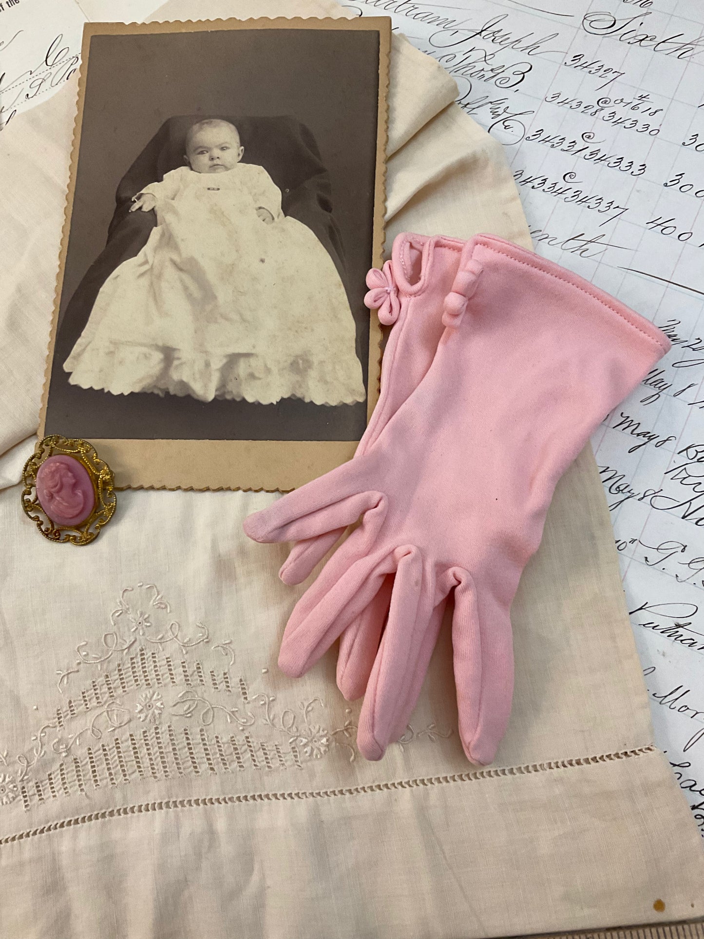 Cameo, photo, child’s gloves, and child size pillowcase